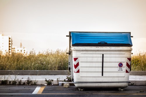 People disposing of furniture at a local recycling center in Crouchend